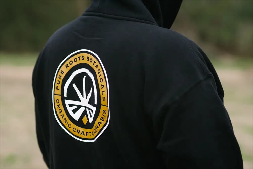 Pure Roots Botanicals Hoodie in hand