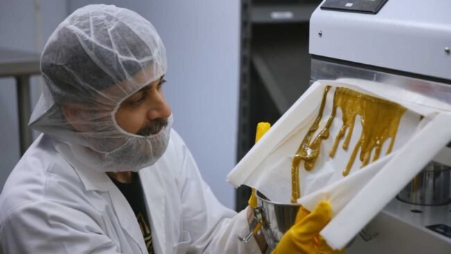Ben next to the Press that squeezes out USDA Certified Organic Live Rosin Concentrate