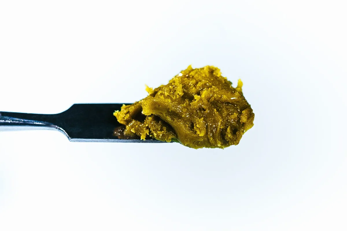 Blackberry Truffle Live Rosin concentrate by Pure Roots Botanicals, golden solventless extract on a dab tool