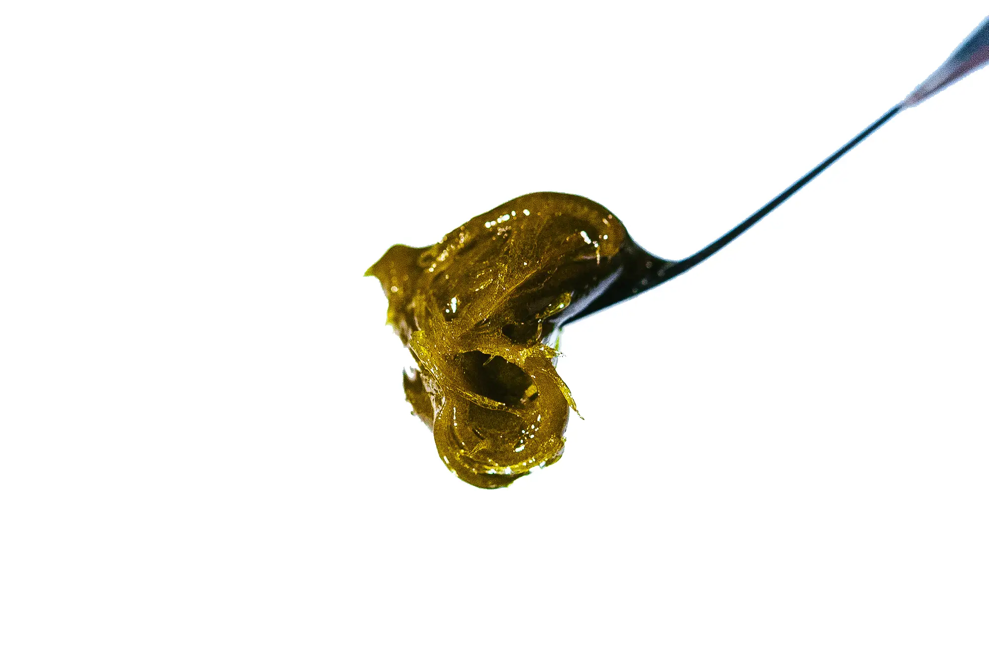 Sticky golden Live Rosin concentrate on a dab tool, showcasing the solventless texture and terpene-rich consistency of Pure Roots Botanicals extract